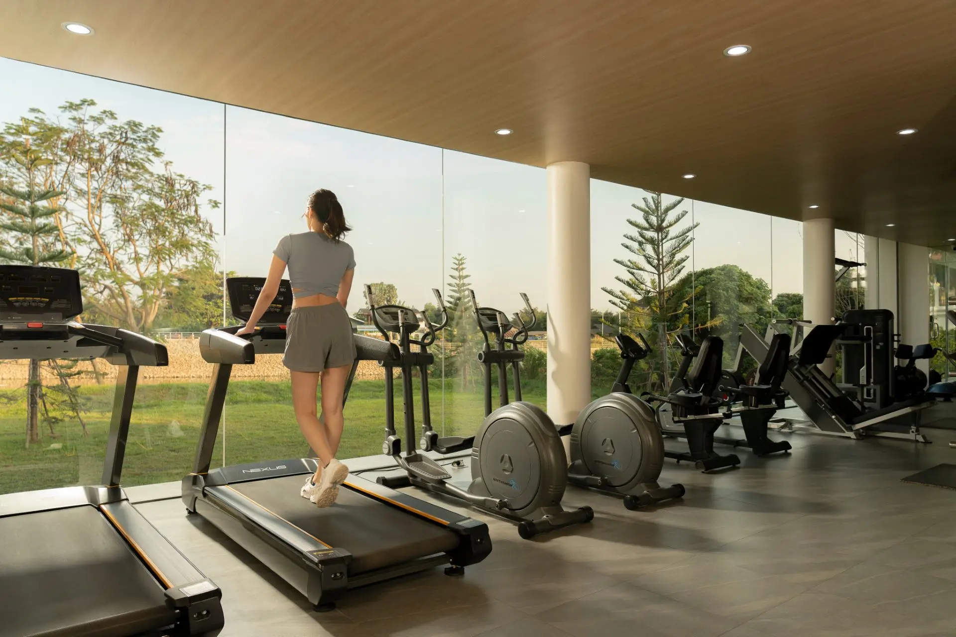 Fitness center with treadmills and garden views at Viva Rehab Thailand in Chiang Mai