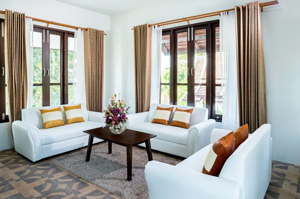 Lounge with white sofas and fresh flowers at Viva Rehab Thailand, a rehab center in Thailand
